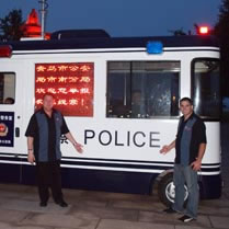 Dave & Jason at May 4th Square in Qingdao in front of mobile police unit