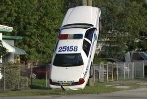 Miami Cop car up pole